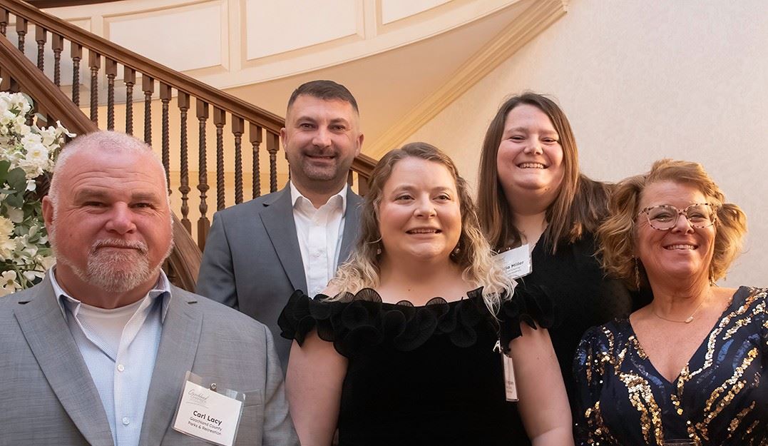 Angelia Miller with Parks and Recreation leadership staff on staircase 
